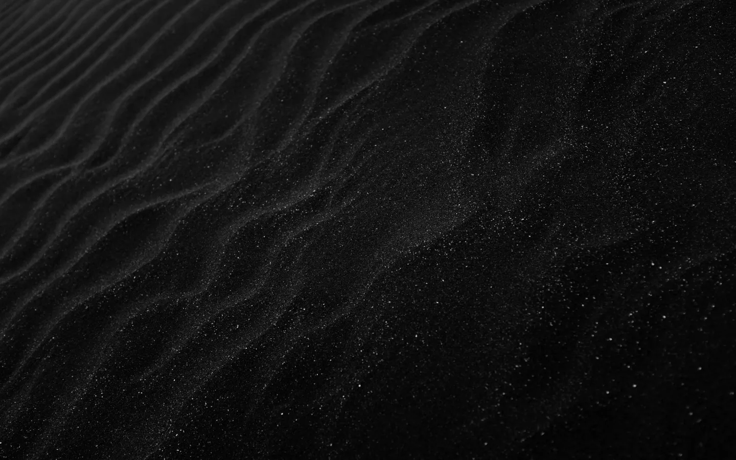 The arid surface of dark sand
