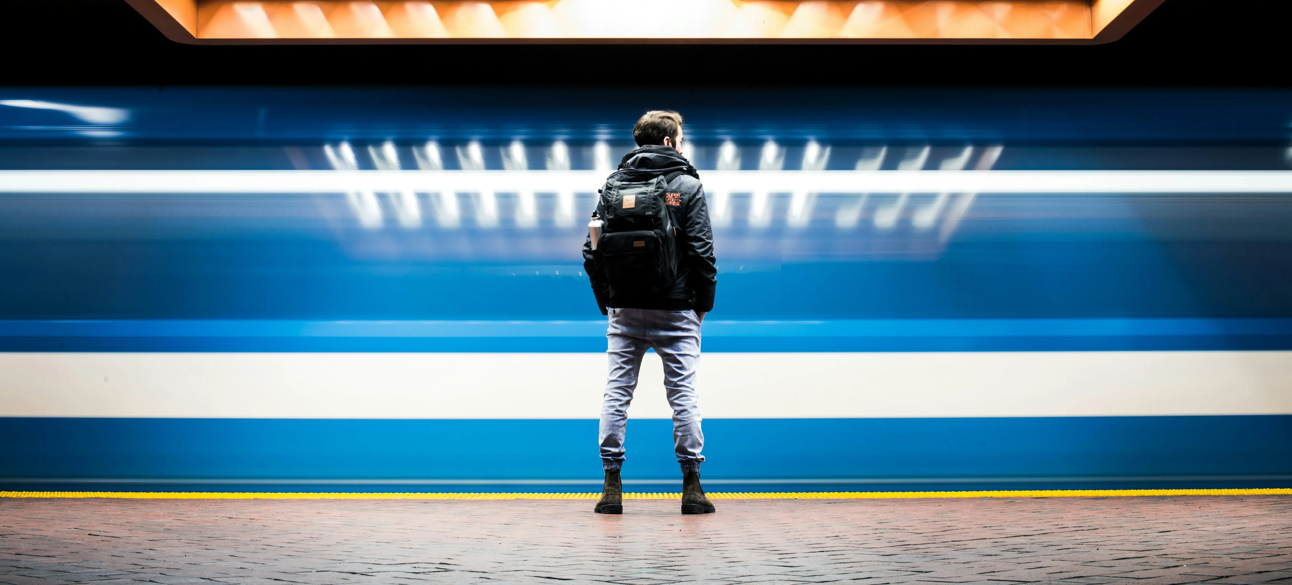 Splash image of a guy standing in front of a subway station